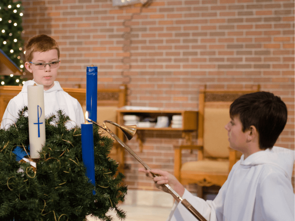 Child lighting candle in church