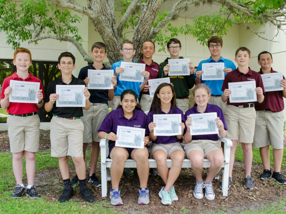 Students holding up awards