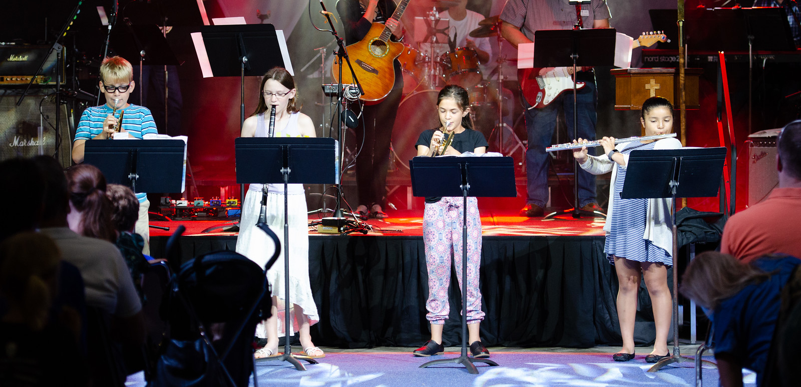 children playing instruments on stage